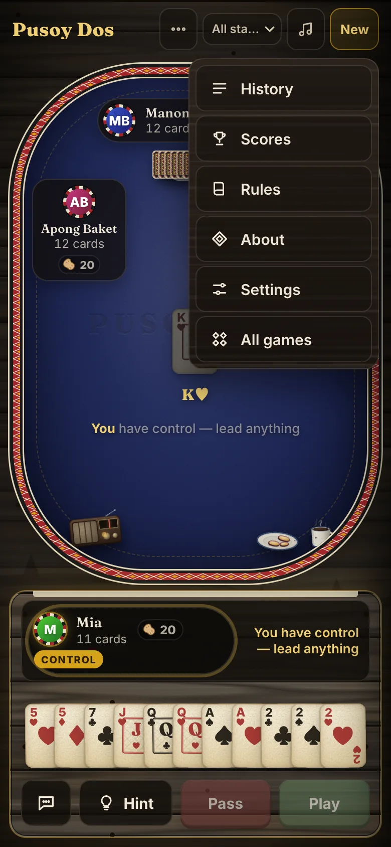 The same screen with the ⋯ menu open, listing History, Scores, Rules, About, Settings and All games.